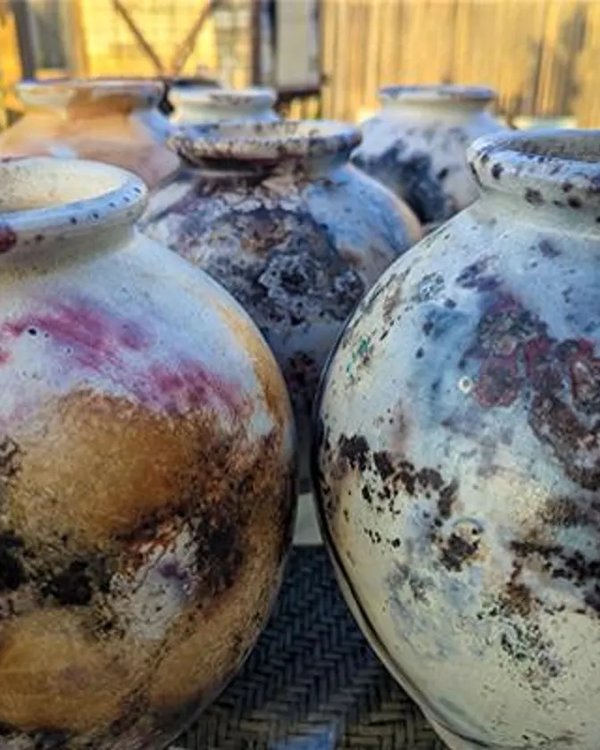 Pit-fired ceramic vessels with organic earth-tone glazing
